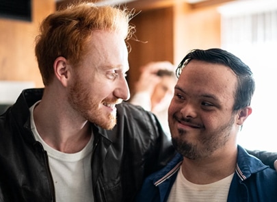 Two men hugging each other