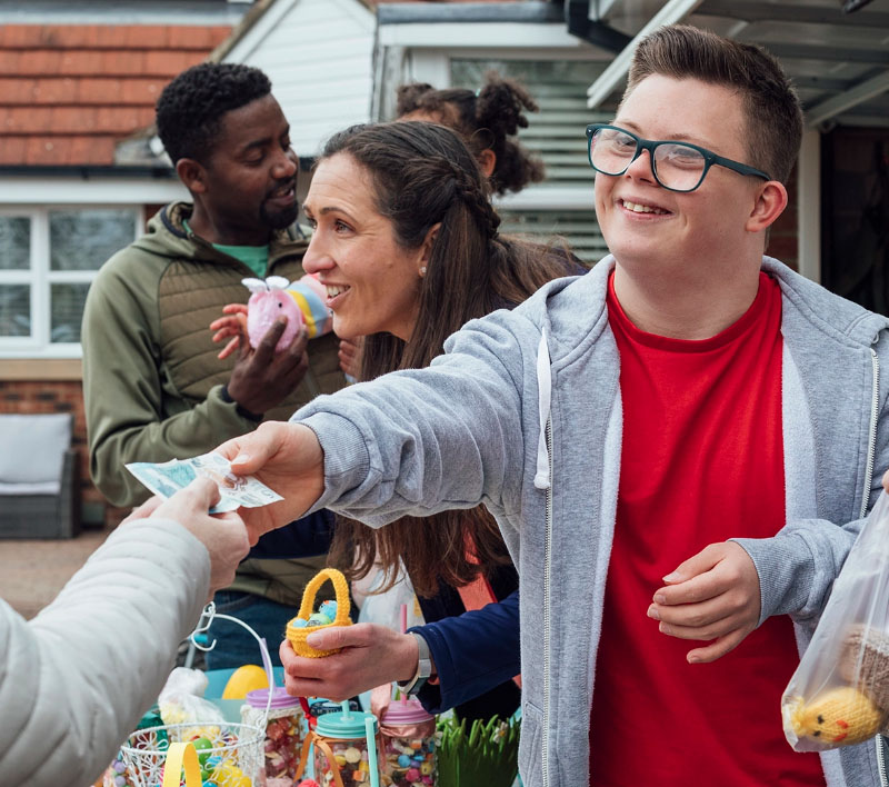 Photo of young person handing out flyers at event 