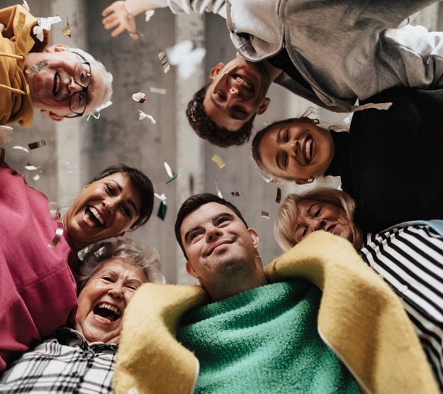 Group of people smiling down at the camera 