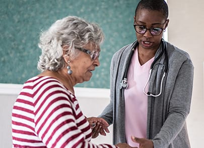 Caregiver helping adult patient 