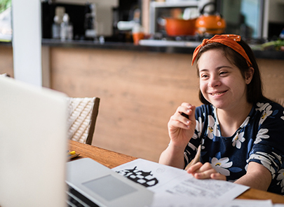 Girl smiling while doing homework 