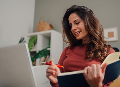 Woman smiling in front of computer screen 