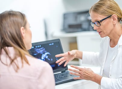 Doctor with patient reviewing scans 