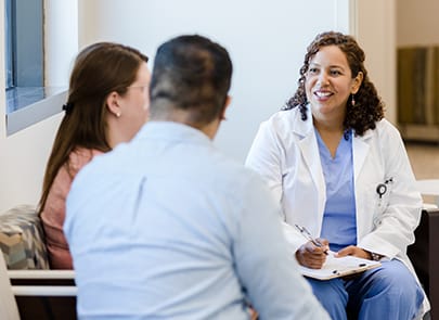 Doctor talking with family in waiting room 