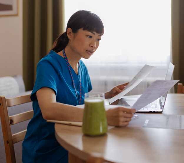 Woman reviewing files in front of computer 