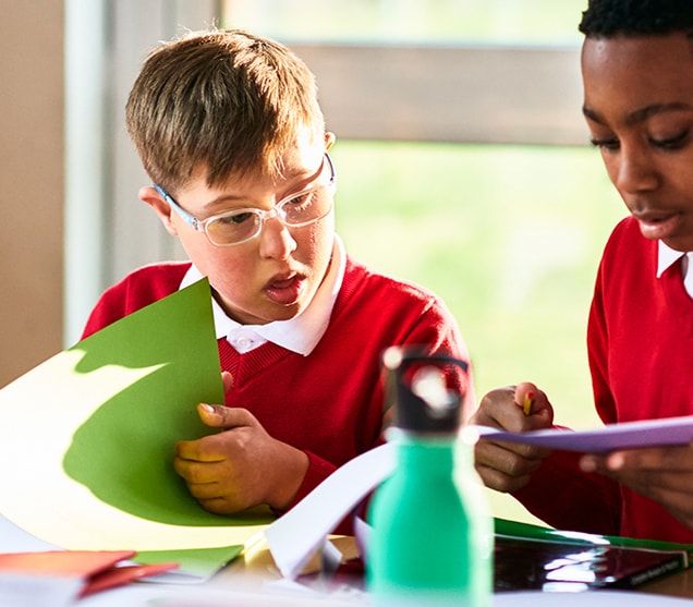 Two children working together in classroom setting 