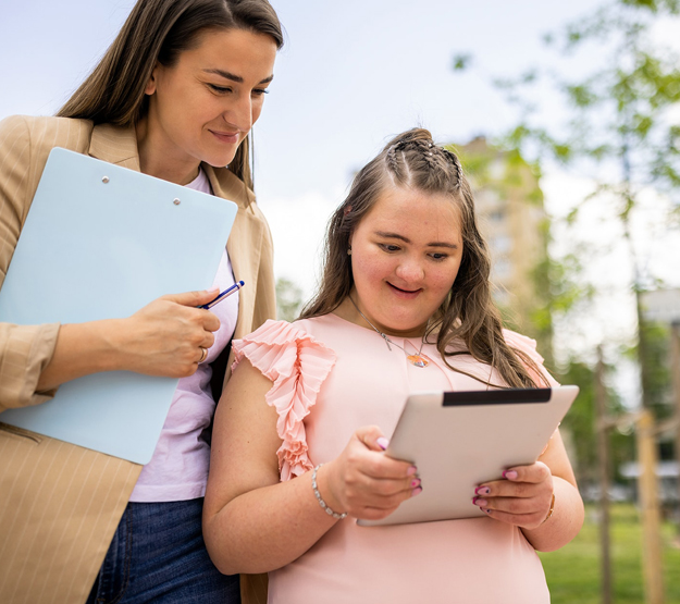 Adult with child holding iPad
