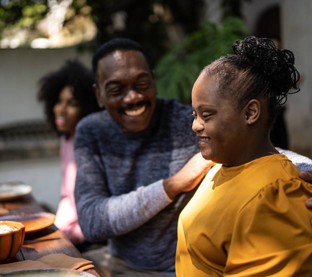 Photo of two adults smiling in a work setting 