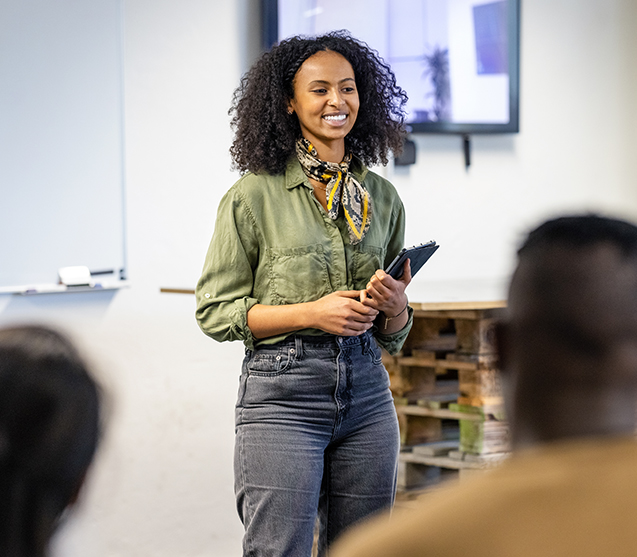 Woman smiling in front of class 