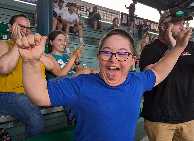 Photo of child cheering at a sporting event 