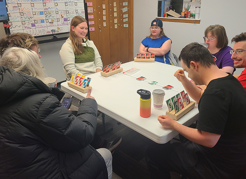group playing game around table 