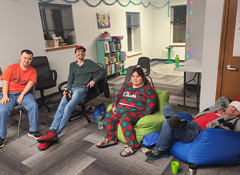 Group sitting on bean bag chairs watching movie 
