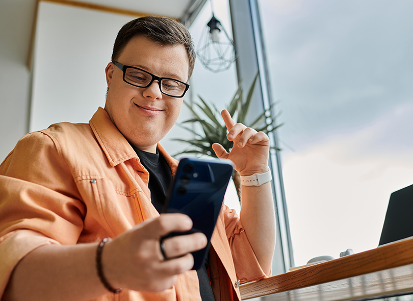 Man smiling at his phone 