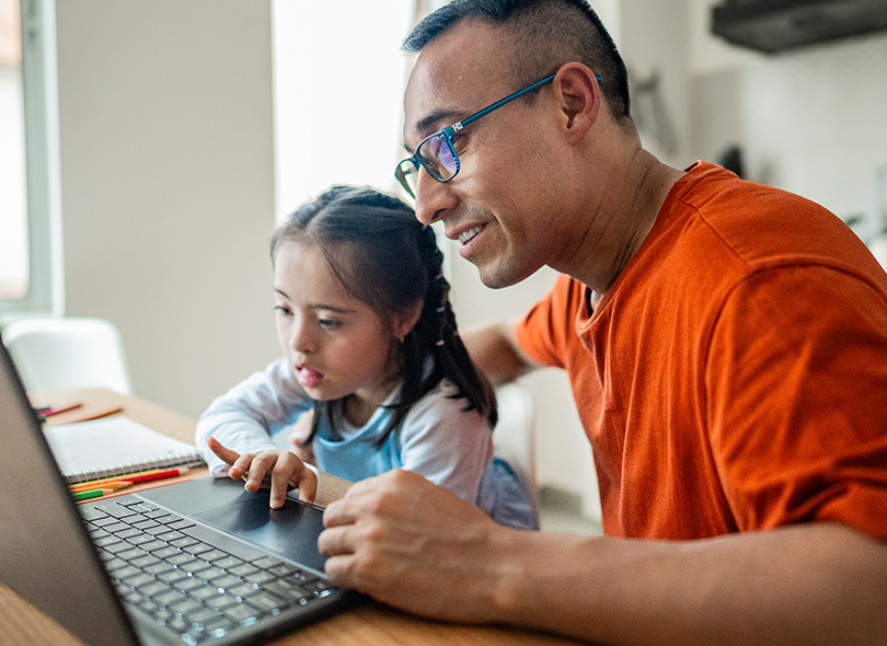 Father with daughter in front of computer 