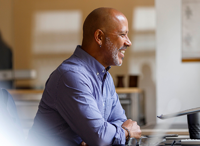 Man smiling at computer