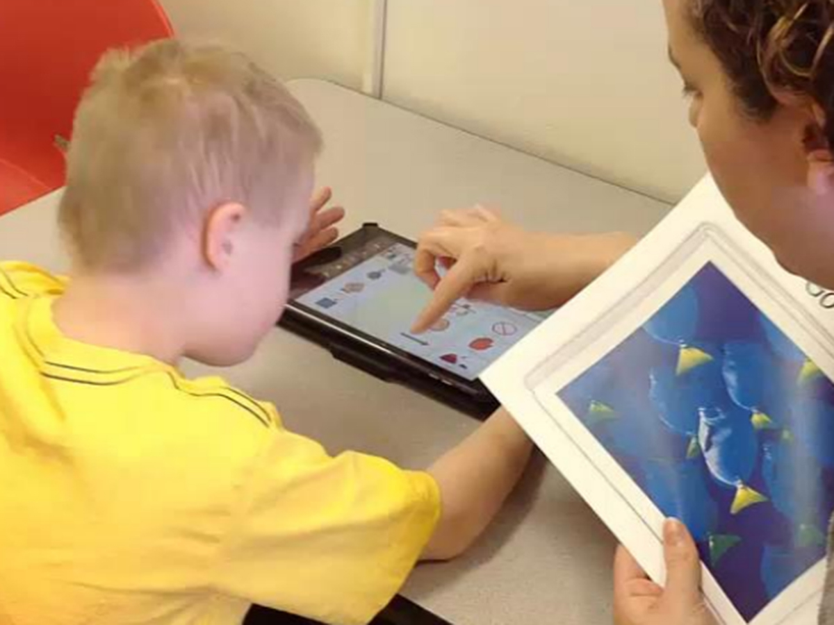 Child using assistive language technology.
