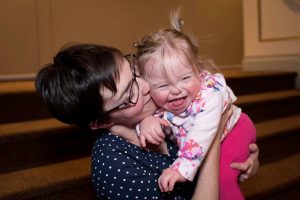 Adult and child laughing.