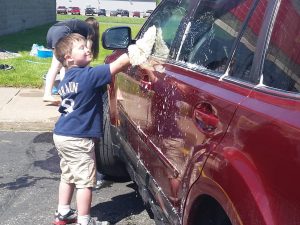 Child washing a car.